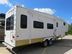white and gold fifth wheel camper.